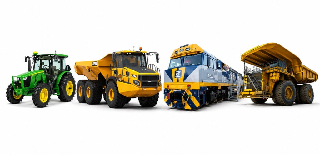 A lineup of heavy machinery on a white background, including a green John Deere tractor, a Bell articulated dump truck, a train locomotive, and a yellow mining haul truck.